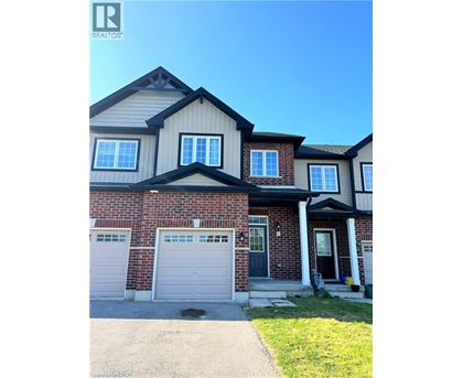 A house with a garage and a driveway in front.