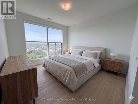 A bedroom with a large bed and a view of the city.