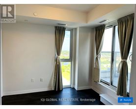 A room with a large window and curtains.