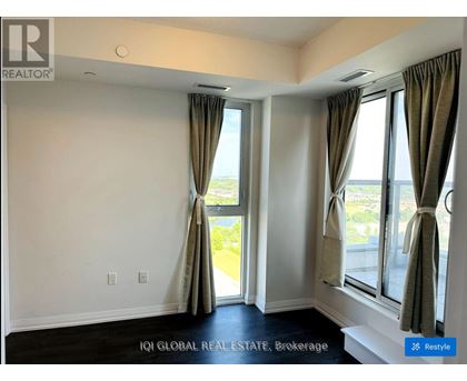 A room with a large window and curtains.