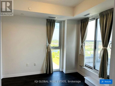 A room with a large window and curtains.