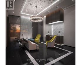A modern waiting room with a glass table and yellow chairs.