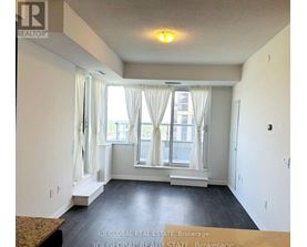 A room with a window and curtains, and a brokerage sign on the wall.