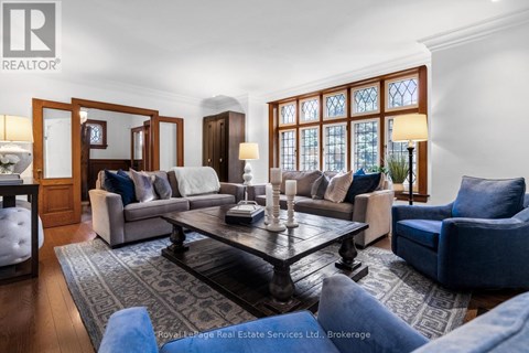 A living room with a large table and blue chairs.