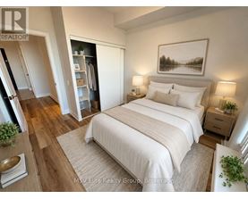 A bedroom with a large bed, a painting on the wall, and a potted plant on the nightstand.