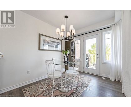 A dining room with a glass table and chairs.