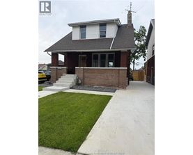 A house with a white roof and a brick chimney.