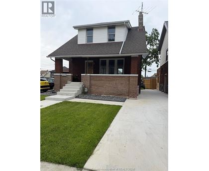A house with a white roof and a brick chimney.