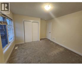 A room with a carpeted floor and a white door.