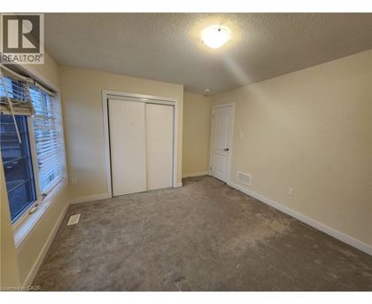A room with a carpeted floor and a white door.