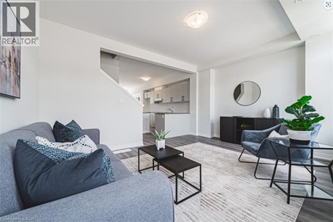 A living room with a grey couch and a black coffee table.