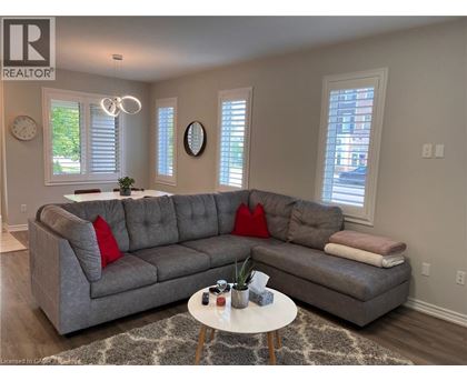 A living room with a grey sofa and a white coffee table.