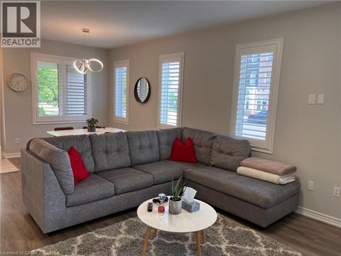 A living room with a grey sofa and a white coffee table.