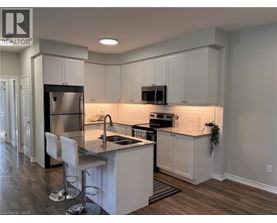 A kitchen with white cabinets and a granite countertop.