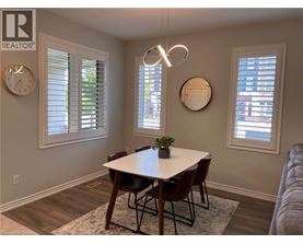 A dining room with a table and chairs.