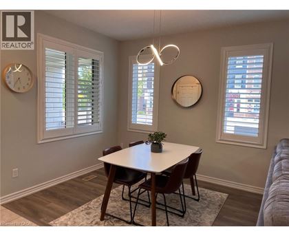A dining room with a table and chairs.