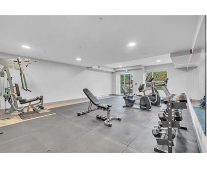 A spacious gym with various exercise equipment.