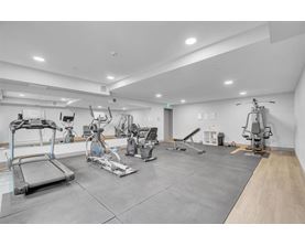 A gym with a variety of exercise equipment.