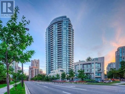 A tall residential building is the centerpiece of a well-maintained urban neighborhood.