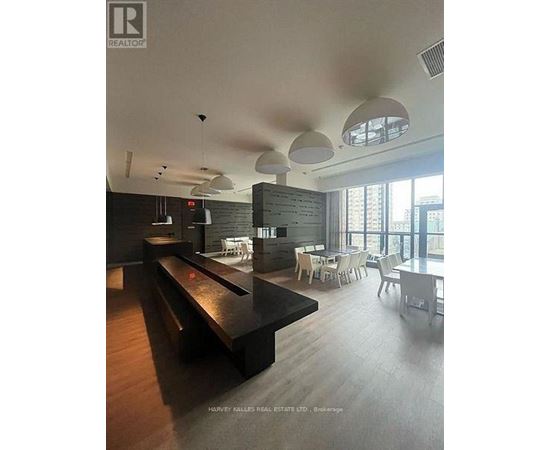 A modern dining area with a long table and chairs.
