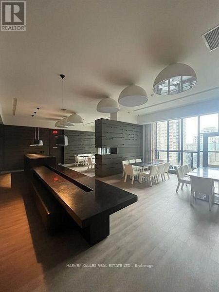 A modern dining area with a long table and chairs.