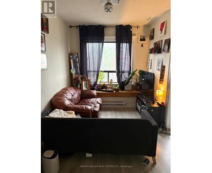 A living room with a brown leather couch and a flat screen TV.