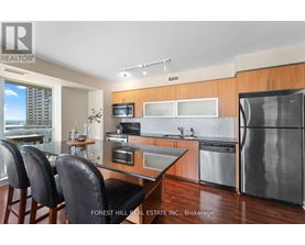 A modern kitchen with a dining table and chairs.