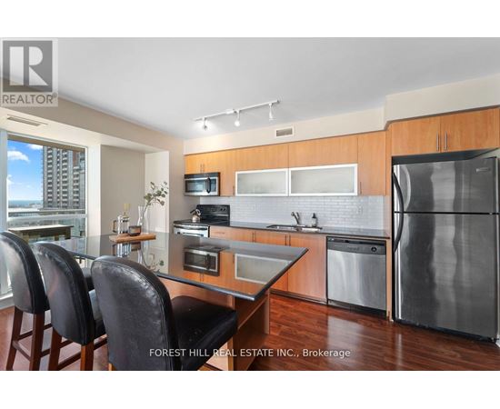 A modern kitchen with a dining table and chairs.