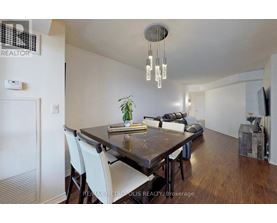 A dining room with a wooden table and chairs.