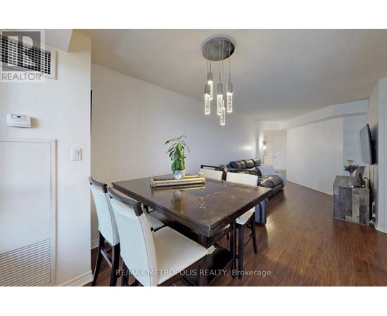 A dining room with a wooden table and chairs.