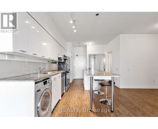 A modern kitchen with white cabinets and stainless steel appliances.