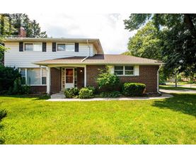 A house with a red brick front and a white siding.