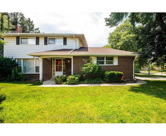 A house with a red brick front and a white siding.