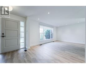 A spacious room with a door and a window.