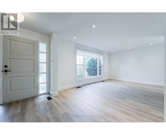 A spacious room with a door and a window.