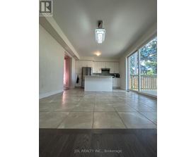 A spacious room with a kitchen island and a large window.