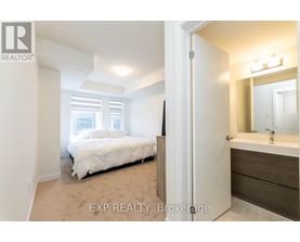 A bedroom with a bed, a dresser and a mirror.