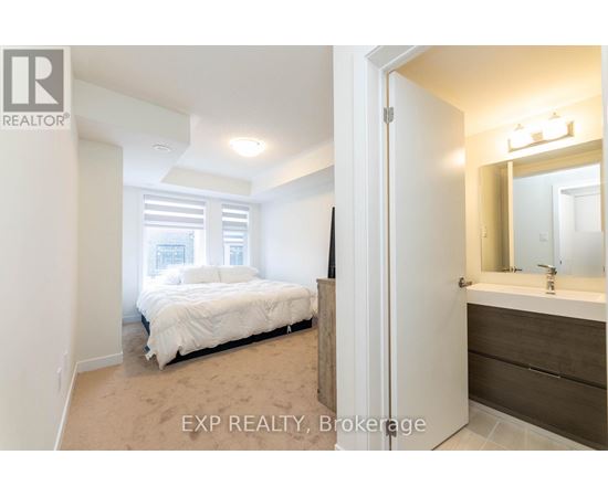 A bedroom with a bed, a dresser and a mirror.