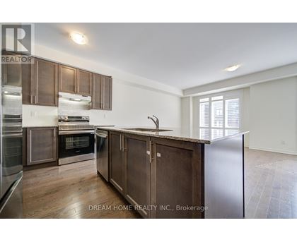 A modern kitchen with wooden cabinets and stainless steel appliances.