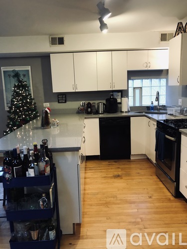 A kitchen with a Christmas tree and a wine rack.