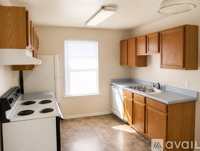 A kitchen with wooden cabinets and a white stove top oven.