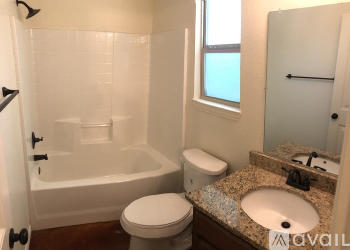 A bathroom with a toilet, sink, and bathtub.