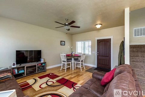 A living room with a brown couch and a television.
