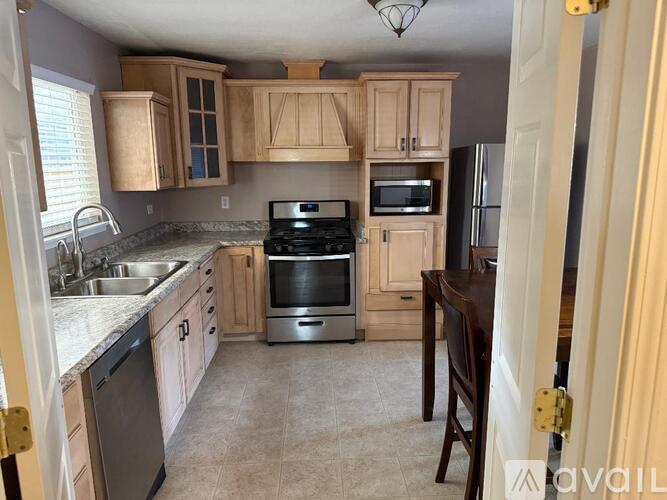 A kitchen with wooden cabinets and stainless steel appliances.