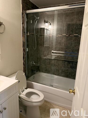 A bathroom with a toilet, sink, and walk-in shower.