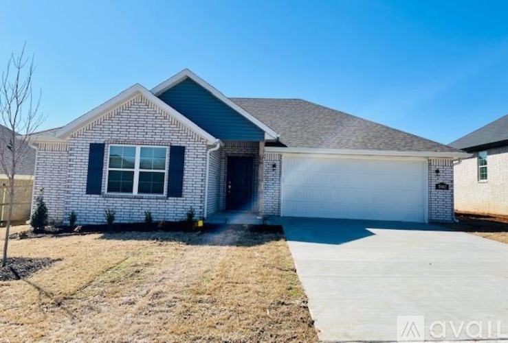 A house with a garage and a driveway in front.