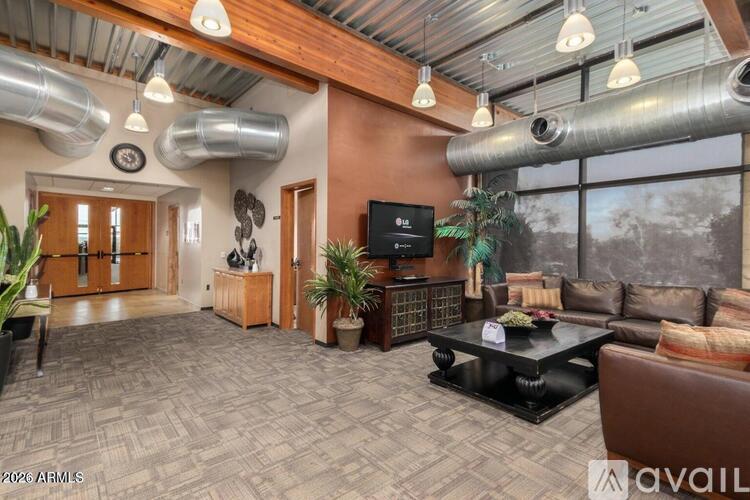 A living room with a black coffee table and a flat screen TV.