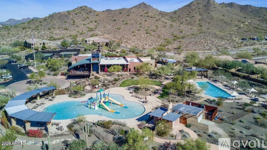 A bird's eye view of a resort with a pool and a slide.
