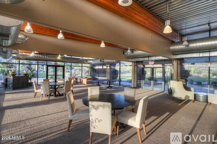 A modern dining area with a long table and chairs.