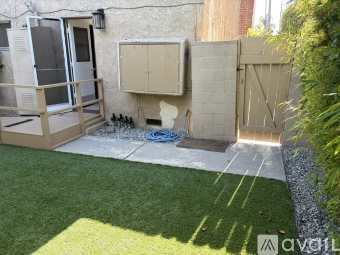 A backyard with a pool and a fence.